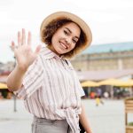 front-view-woman-smiling-waving-min-compress